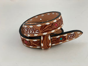 Ellie Baby Belt. Antique Floral Tooling, Ivory Buckstitch with Name on Back. Colorful Flower Centers and Initials on Tip.